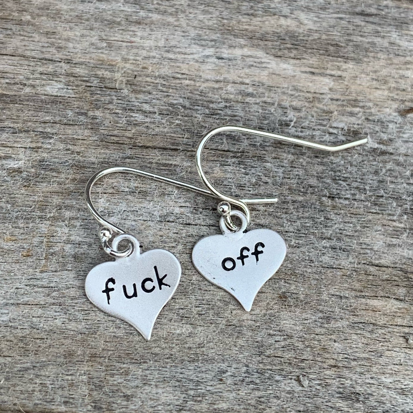 Pair of sterling silver earrings - heart shape- “fuck off”