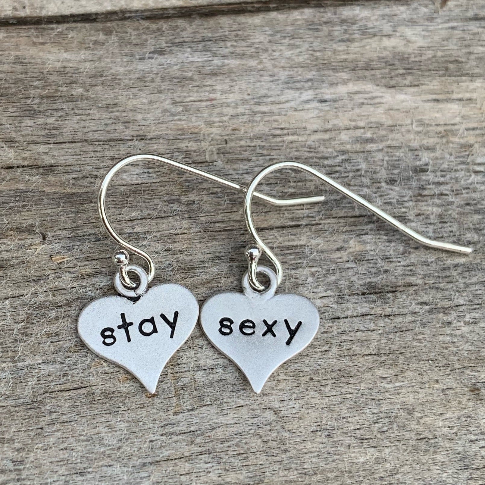 Pair of sterling silver earrings - heart shaped - “stay sexy”